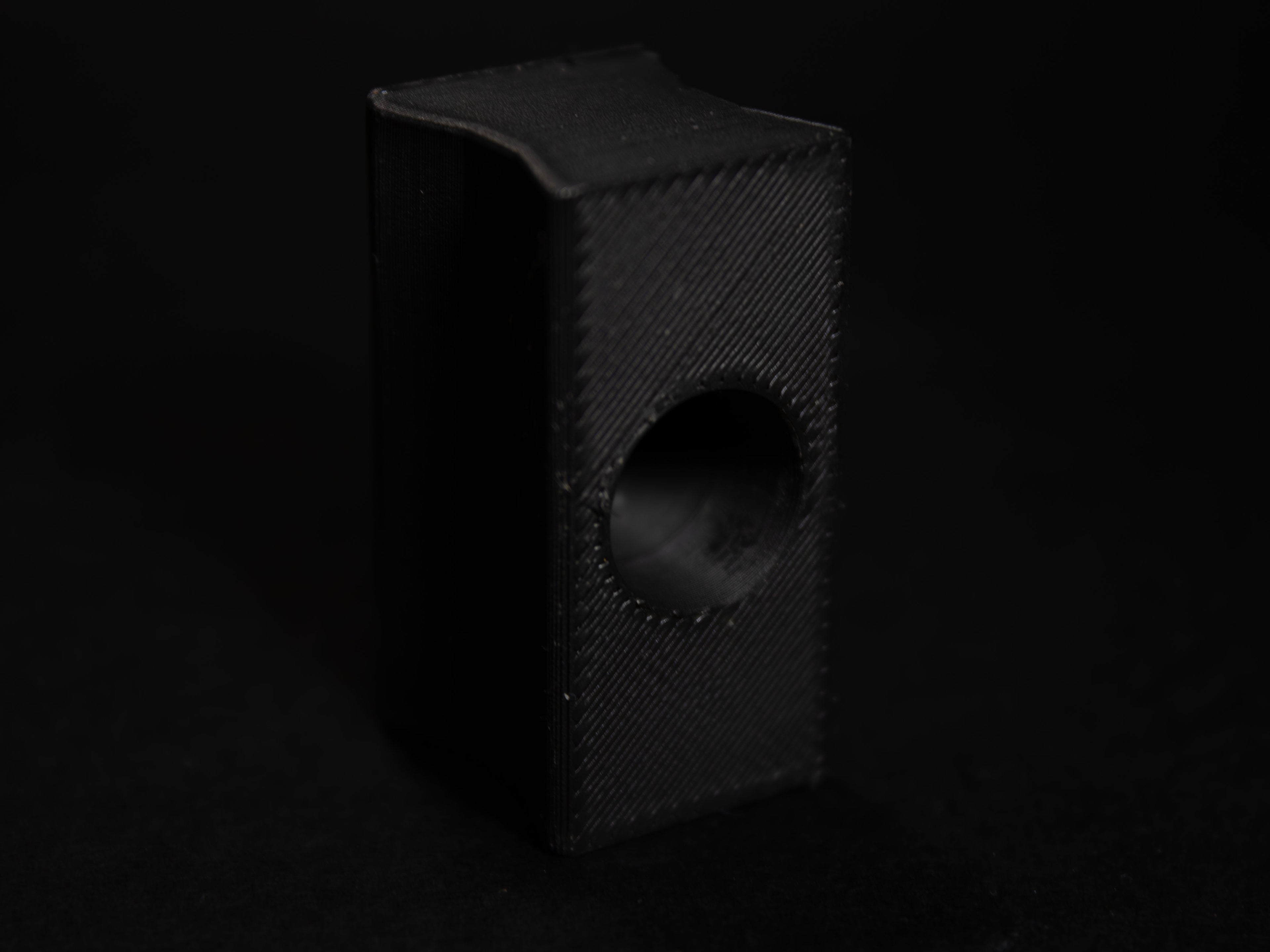 Black rubber block accessory with a hole, ideal for various DIY projects and repairs.